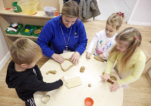 nursery worker baking with children