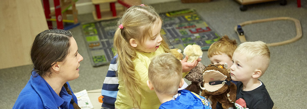 little girl playing with animals