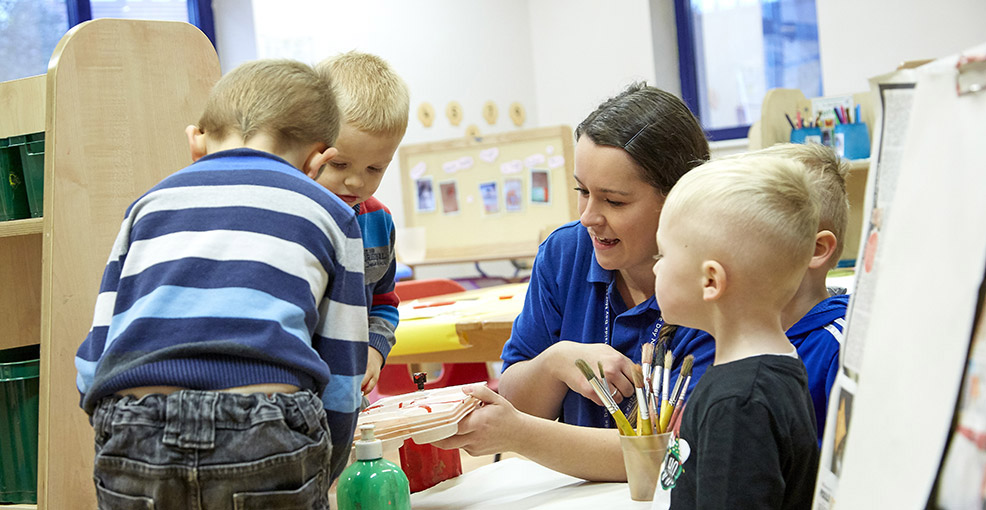 Nursery worker playing with childre at Longhill Nursery